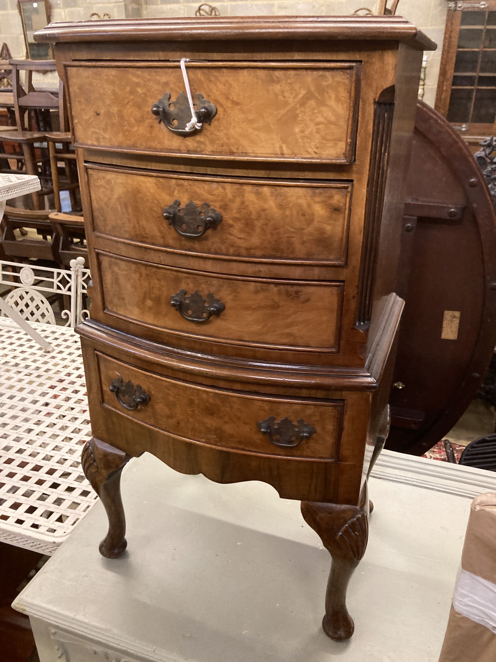 A reproduction walnut four drawer bedside chest, width 42cm depth 29cm height 76cm